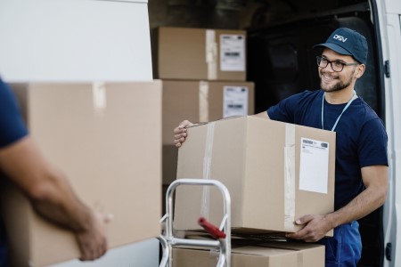 DSV male employee carrying a parcel into a delivery truck. | DSV Direct Blog